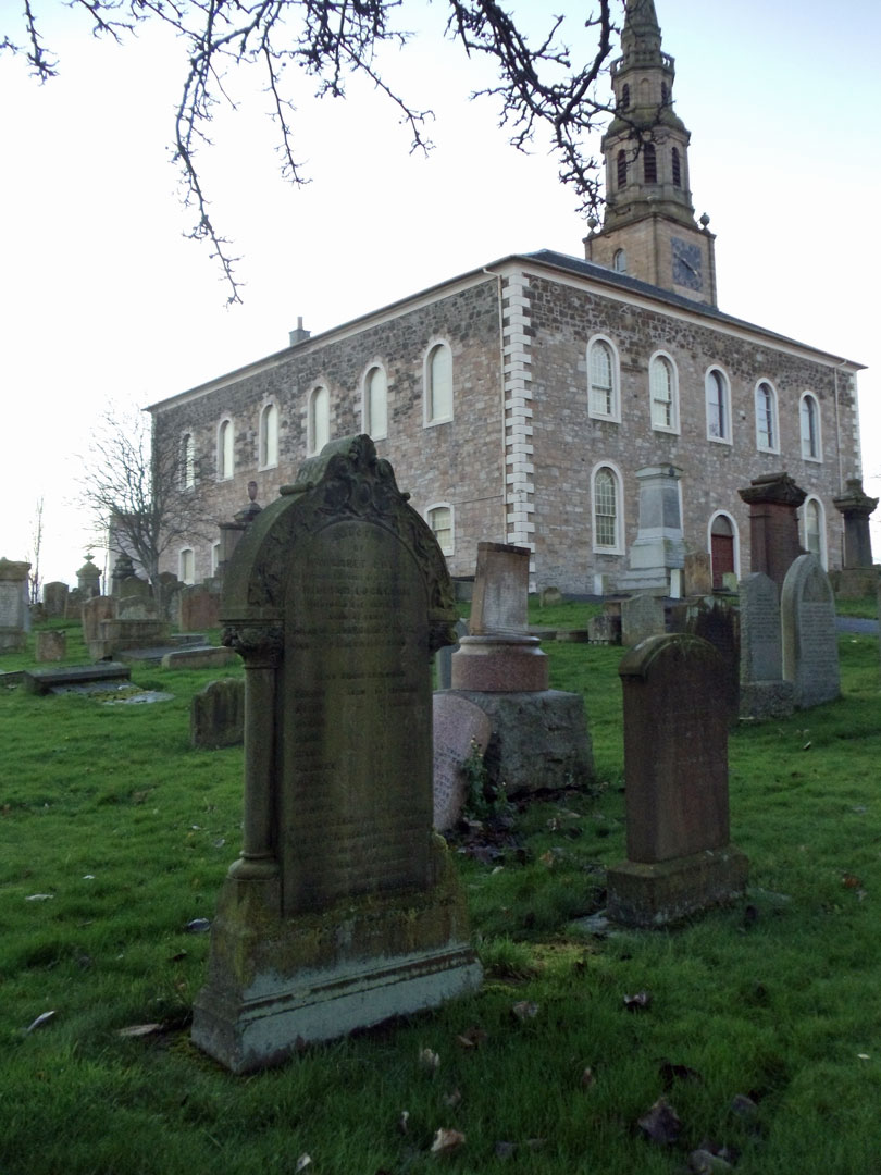 The gravestone for the family of William Lockerbie and Margaret Potts is in the foreground, with a view of Irvine Old Parish Church in the background. Irvine, North Ayrshire, Scotland. (2569 KB) 5 December 2014 Photo taken by William Kerr; used by permission. For other Irvine Churchyard inquiries, please contact local historian William Kerr (bkstinan@msn.com), founder of the Irvine Kirkyard Preservation Group. (Click on Picture to View Full Size) picture