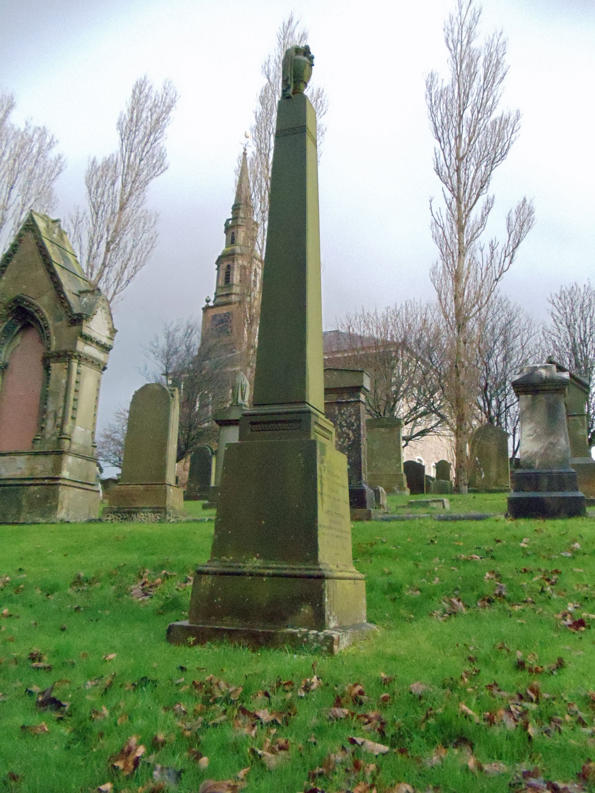 Rear view (Side D) of the David Topping and Mary Boyd family obelisk in Irvine Kirkyard (gravestone U46). Note there are no inscriptions carved on this side. (5321 KB) 7 December 2014 Photo taken by William Kerr; used by permission. For other Irvine Churchyard inquiries, please contact local historian William Kerr (bkstinan@msn.com), founder of the Irvine Kirkyard Preservation Group. (Click on Picture to View Full Size) picture