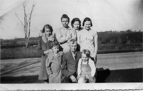 'Three Generations.' Tillie (back row, second from left) with either her father or her second husband. (470 KB) Abt 1940 Photo from FindAGrave; Added by: Denise Gill, 11/12/2014 Genealogists disagree on whether the man is Tillie's father, or her second husband David Allen Gilbert (both men were about the same age). Does the three generations refer to Tillie's father, herself and her children; or to Tillie, her daughter(s), and her grandchildren? (Click on Picture to View Full Size) picture